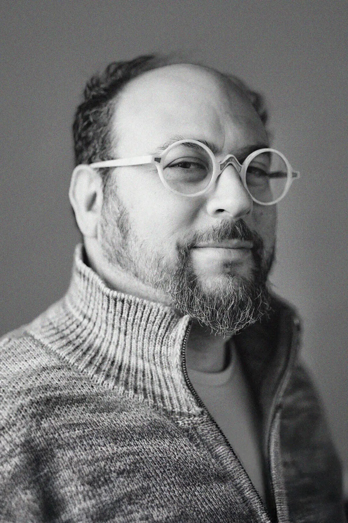 Seth Goldenberg with a confident expression photographed from the shoulders up in a minimalist studio setting.
