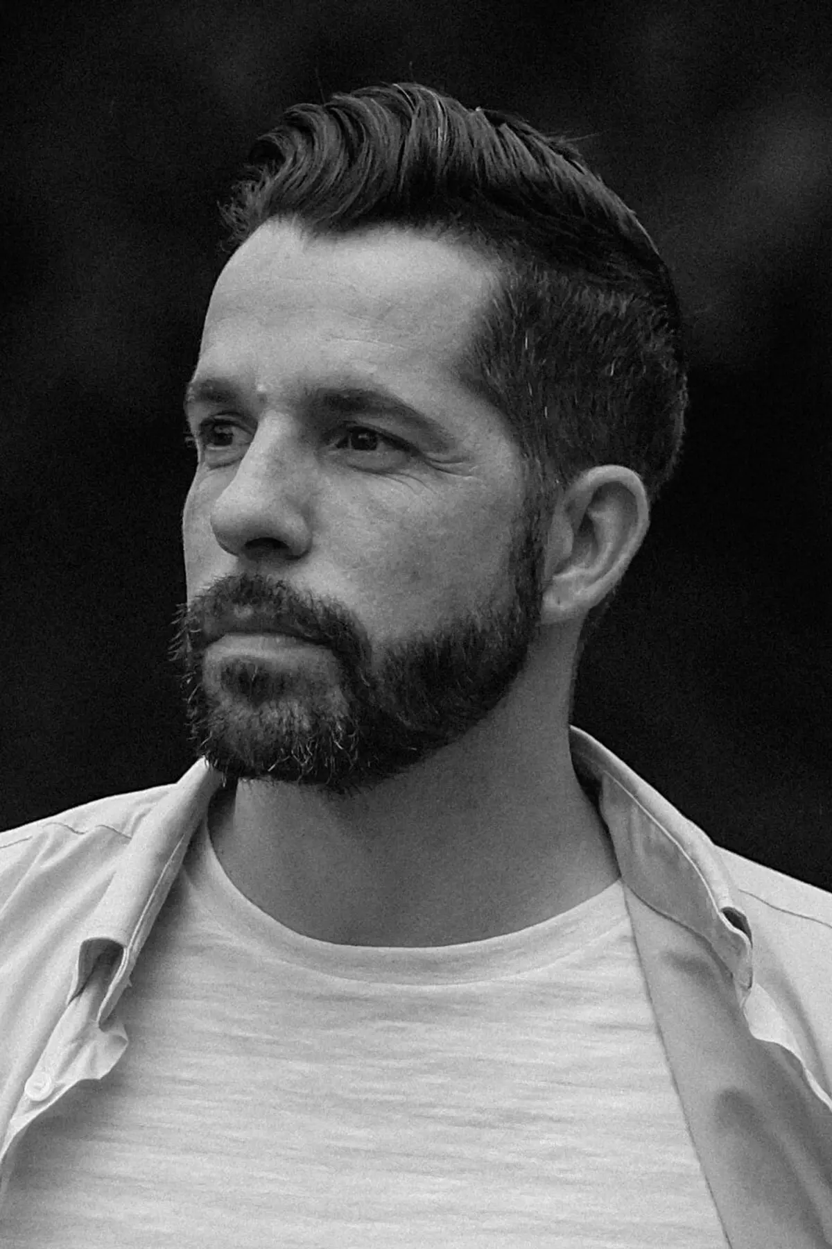 Nick Rock with a confident expression photographed from the shoulders up in a minimalist studio setting.