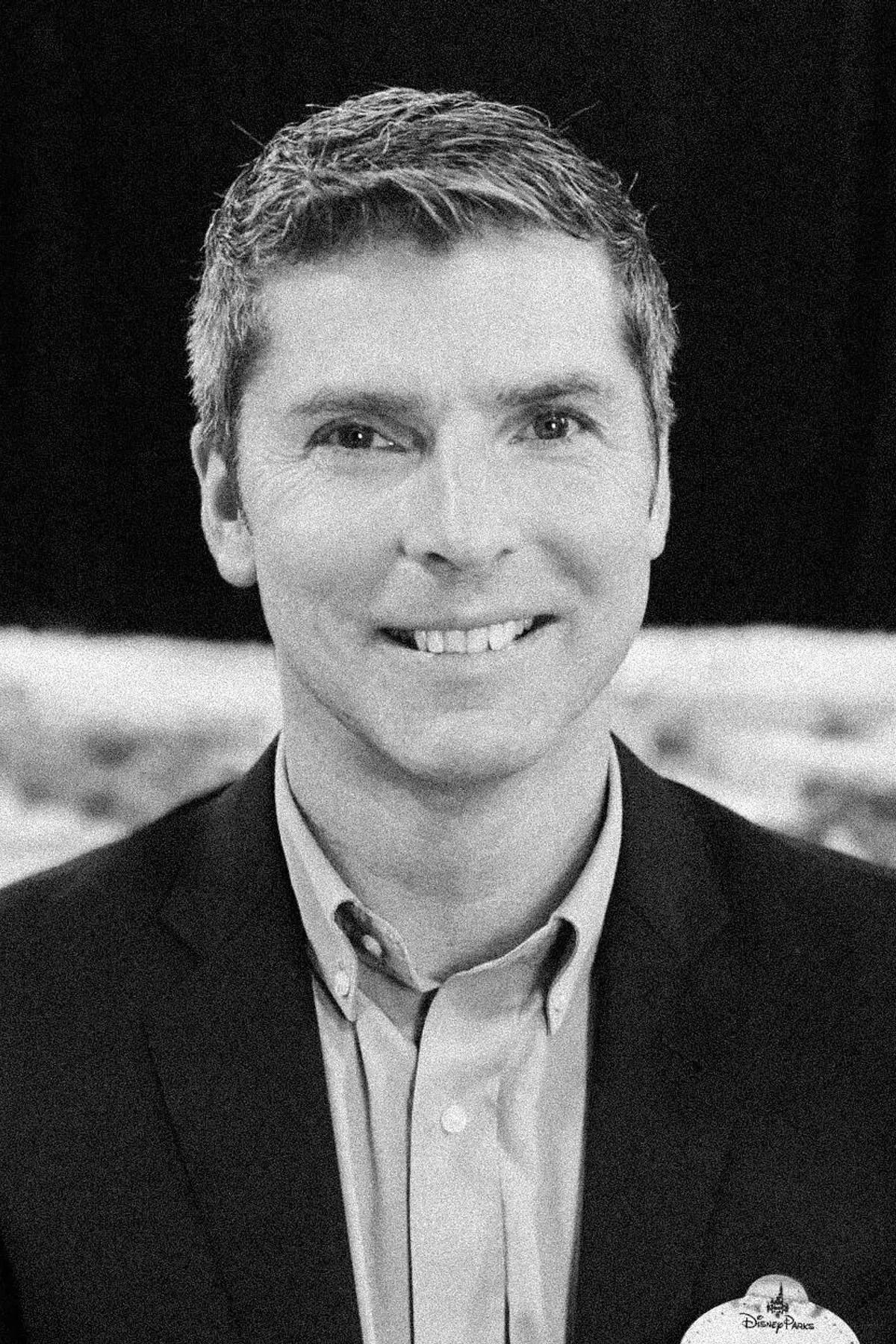 Bruce Vaughn with a confident expression, wearing professional attire, photographed from the shoulders up in a minimalist studio setting.