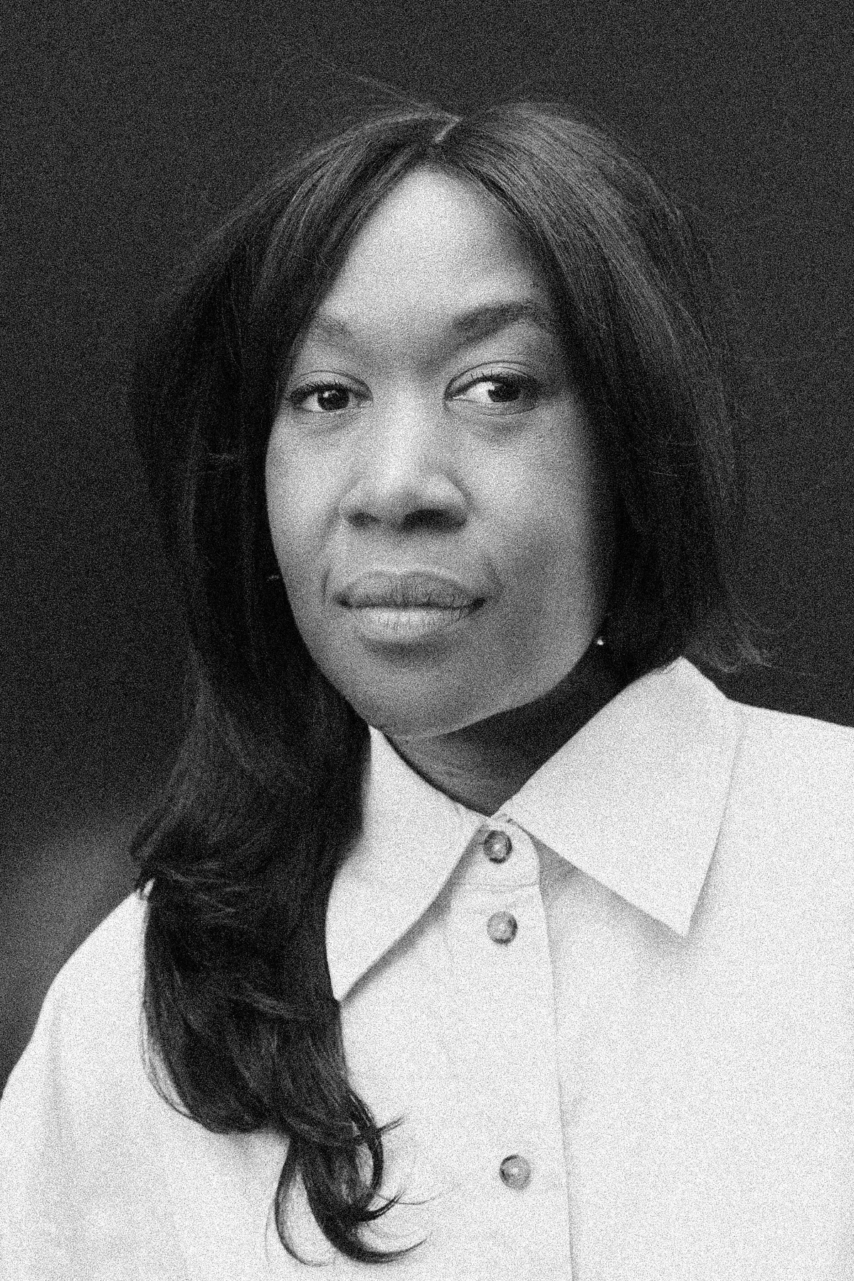 Natsai Audrey Chieza with a confident expression, wearing professional attire, photographed from the shoulders up in a minimalist studio setting.